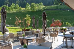 a restaurant with tables and chairs and umbrellas at Hotel Badia Hill in Badia +98 photos