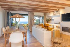 a living room with a couch and a table at La Casa del Faro de Llafranc in Llafranc