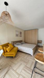 a bedroom with a bed and a couch at Habana in Saint-Laurent-du-Var