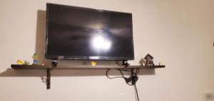 ein Flachbildfernseher auf einem Regal an der Wand in der Unterkunft Galaxy House in Sun City