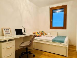 a bedroom with a bed and a desk with a laptop at Joy City Stay Fructus 30 in Timişoara