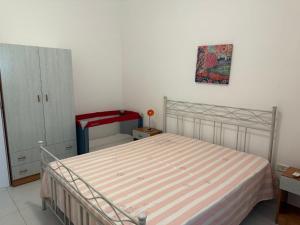 a bedroom with a bed and a dresser at Torre Lapillo in Torre Lapillo