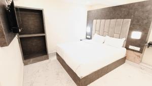 a white bed in a room with a television at Hotel Richie Residency in Mumbai +21 photos
