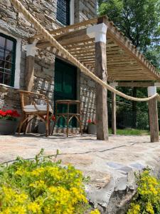 a patio with a table and a chair in front of a building at Cabin Valle Cervo 