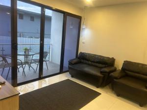 a living room with a couch and a table at Residence 50 Apartment Nausori in Nausori