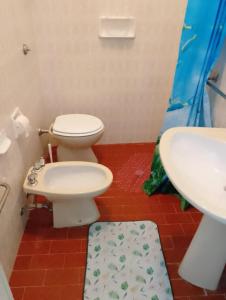 a bathroom with a toilet and a sink at La casa di Anna Maria in Nardò +8 photos