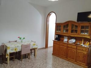 a dining room with a table and a tv at La casa di Anna Maria in Nardò