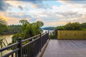 a balcony with a view of a river at Hotel Malika Inn 