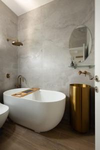 a bathroom with a white tub and a mirror at The charm of Jerusalem in Jerusalem