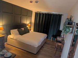 a bedroom with a bed and a table with a chair at The Castle Inn hotel 