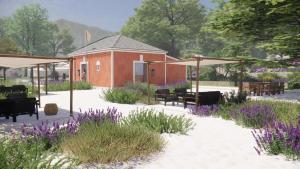 a garden with purple flowers and a building at Makryammos in Limenas