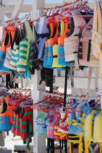 a rack of colorful shirts on display in a store at Makryammos in Limenas