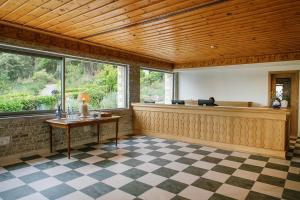 an empty lobby with a reception desk and windows at Makryammos in Limenas
