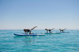 a group of people on surfboards in the water at Makryammos in Limenas