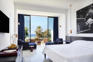 a bedroom with a bed and a view of the ocean at Almyra in Paphos +107 photos