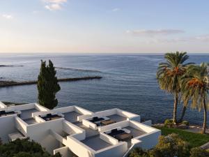a rendering of a white building overlooking the ocean at Almyra in Paphos
