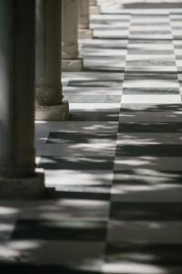 a tile floor with columns in a building at Makryammos in Limenas