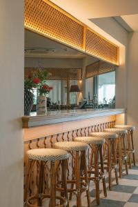 a row of stools at a bar with a mirror at Makryammos in Limenas