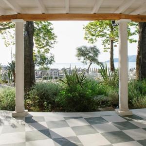 a porch with columns and a checkered floor at Makryammos in Limenas