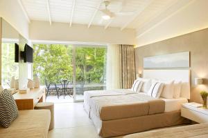 a bedroom with two beds and a balcony at Makryammos in Limenas