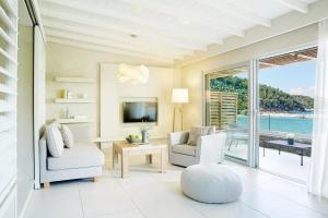 a living room with a view of the ocean at Makryammos in Limenas