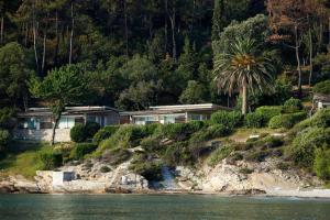 a house on a hill next to the water at Makryammos in Limenas