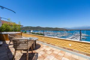 a patio with a table and chairs overlooking a marina at Hotel Unique-Boutique Class - Adults Only in Fethiye