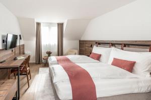 Voodi või voodid majutusasutuse Tailormade Hotel KRONE Sarnen toas