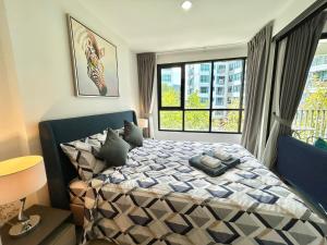 a bedroom with a bed and a large window at 1 Bedroom Condos Close to Shopping Malls in Ban Rangeng +18 photos