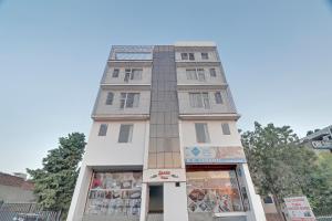 a tall building with a store in front of it at HOTEL O THE ROYAL INN in Jaipur