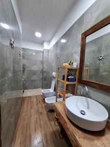 a bathroom with two toilets and a sink at DeJon Apartment in Gjilek +22 photos