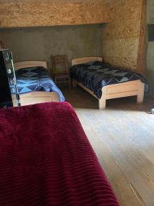 a bedroom with two beds in a room at Guesthouse Tushetian Tower in Omalo