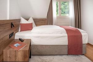 Voodi või voodid majutusasutuse Tailormade Hotel KRONE Sarnen toas