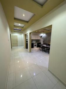 a large room with a kitchen and a dining room at شاليه هاشتاق الودي in Al Wudayy
