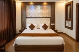 a bedroom with a large bed in a room at Hotel JP International in Katra +20 photos