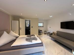 a living room with a bed and a couch at Haus Deitje in Borkum