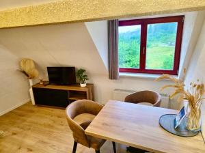 a dining room with a table and a window at Allgäuer Ferienwohnung mit Schwimmbad- und Sauna-Zugang in Wiggensbach