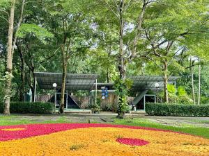 a large circle of flowers in front of a building at Nunou Cafe in Ban Than Lao