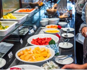 a buffet line with bowls of fruit and plates of food at Bodrum Eskiçeşme Lumy Hotel - Private Pool in Bodrum City