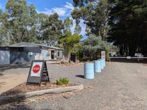 a stop sign in the middle of a road at Tiny Homes Escape at Grampians Edge by Tiny Away in Dadswells Bridge