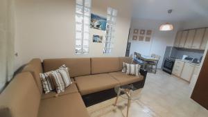 a living room with a couch and a kitchen at Andreadis maissonette in Skala Potamias