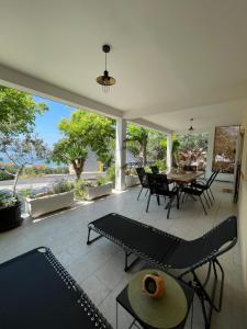 a living room with a patio with a table and chairs at Superior Apartman Vujević, Duće in Duće