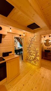 a kitchen with a wall with a tree in it at PARADiSE Wellness Chalet - Sauna&SPA Terchová in Terchová