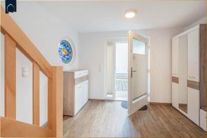 a white room with a staircase and a window at Ferienwohnung Haffblick in Kamminke +25 photos