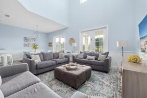 a large living room with couches and a table at Three Palms in Palm Coast