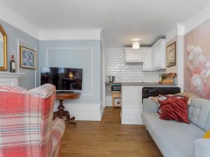 a living room with a couch and a tv at Pass the Keys Bright Town-Centre Flat with Outdoor Area in Ulverston