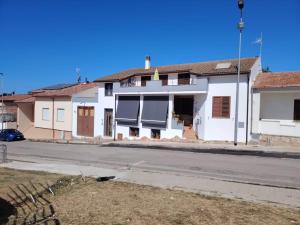 a white house on the side of a street at Zeus Casa Vacanza in Olmedo