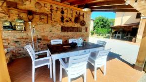 a dining room with a table and white chairs at Il Casale di Lucullo-Holiday Home with Pool and Spa- in Lucignano +57 photos