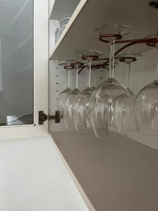 a row of wine glasses sitting on a shelf at Holiday Nest 2 in Sønderborg
