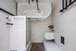 a bathroom with a white toilet and a sink at Baltijos parkas - Šventoji in Šventoji +54 photos